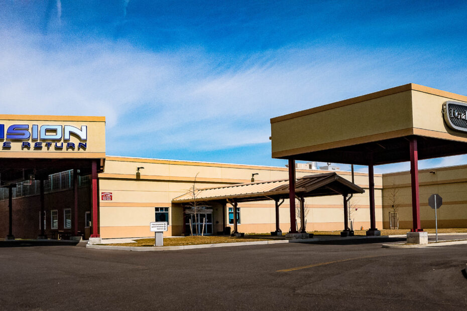 Fusion Lease Return building exterior with drive-up canopy and signage
