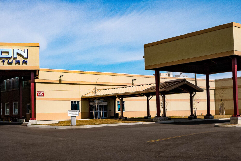 Fusion Lease Return building exterior with drive-up canopy and signage