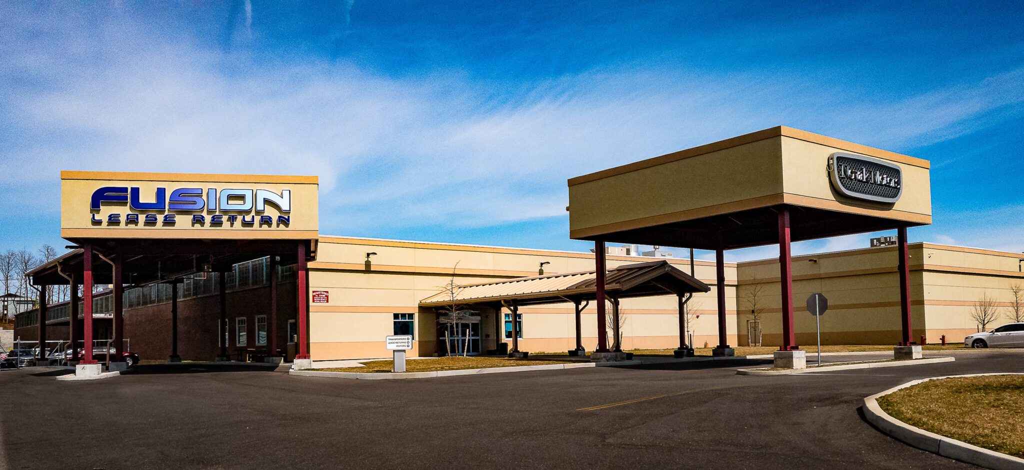 Exterior of Fusion Lease Return and Novak Motors facility in Farmingdale, New York, showcasing the 120,000-square-foot expansion that increased Fusion Auto Finance’s capacity in 2016.